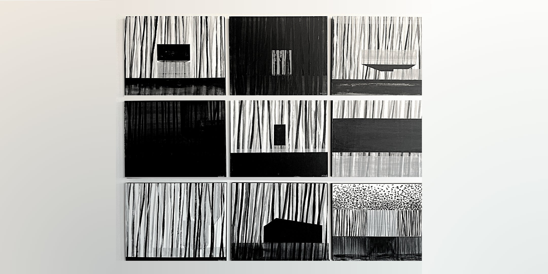 Black and white abstract art pieces on a white wall by Rita Rawashdeh